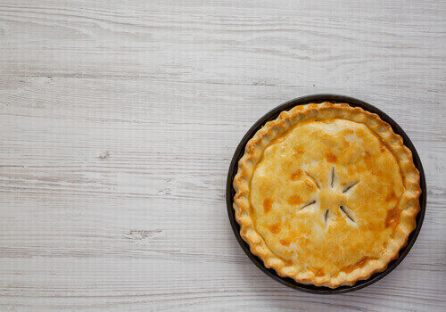 A Piece Of Chicken Pot Pie On A White Wooden Background, Top Vie